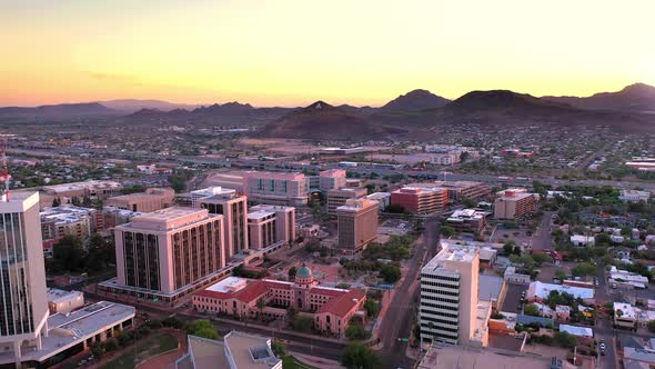 Tucson Arizona, aerial drone descending over Old Pima County Courthouse during vibrant sunset.