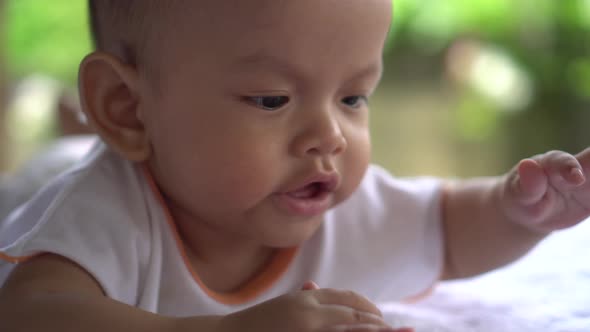 Happy portrait baby boy playing alone