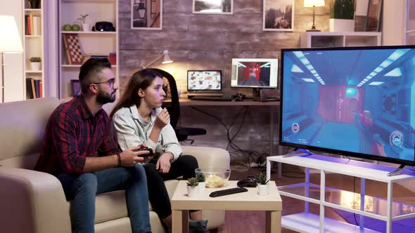 Girl Eating Chips While Boyfriend Is Playing Video Games