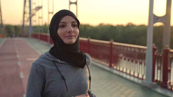 Lovely Muslim Female in Hijab Jogging Outdoors