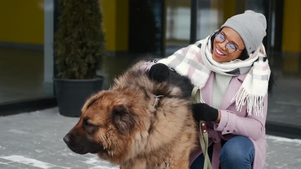 Woman Walking Cute Dog Outdoors on Winter Day