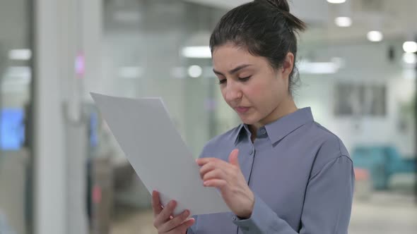 Portrait of Young Indian Woman Reading Papers