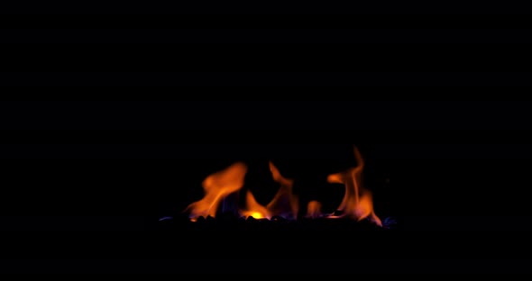 The Fire starts burning. Closeup of flames effect isolated on black background footage