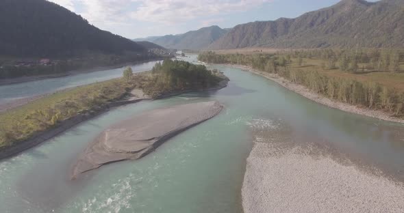 Low Altitude Flight Over Fresh Fast Mountain River with Rocks at Sunny Summer Morning