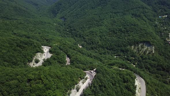 Aerial View From Above of Curve Road with a Car on the Mountain with Green Forest in Russia