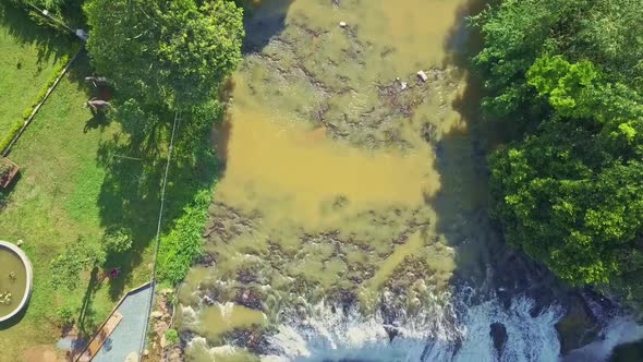 Aerial Motion Along River To Giant Waterfall in Tropics