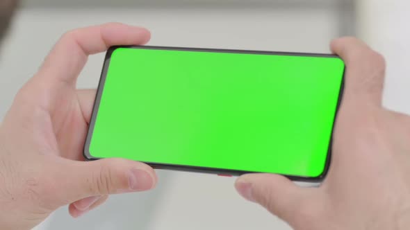 Close Up of Young Man Watching Smartphone with Chroma Screen