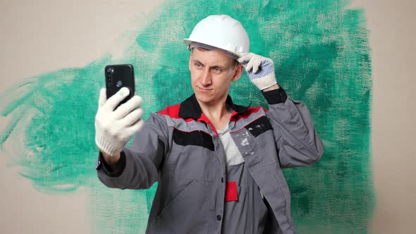 Focused Construction Blogger Shoots Video on Smartphone