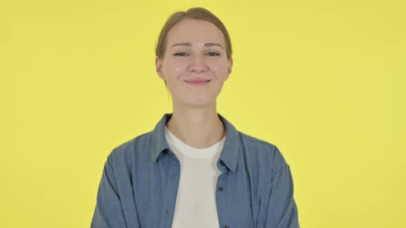 Young Woman Shaking Head As Yes Sign on Yellow Background