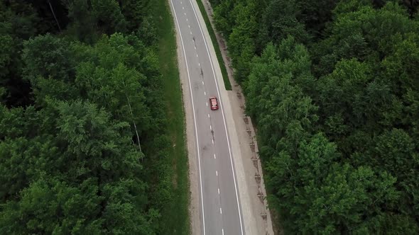 Drone Point of View Tracking Mode Aerial View Flying Over Two Lane Countryside Forest Road with