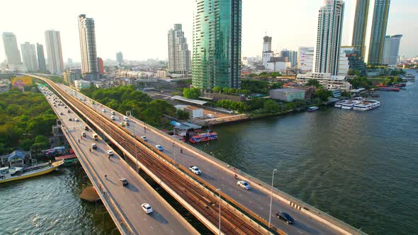 4K : Drones fly over the Chao Phraya River, buildings and business districts in Bangkok