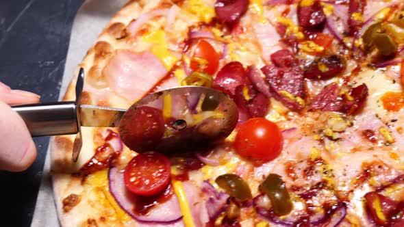 Closeup Cutting Pizza with a Round Cutter Knife Slow Motion