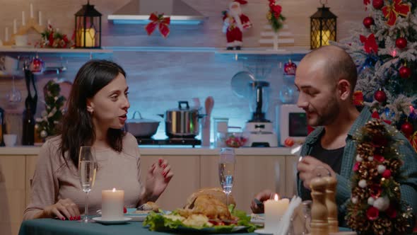 Man and Woman Celebrating Christmas at Festive Dinner