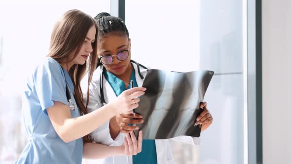 Two Doctors Studying Xray Image in Bright Office