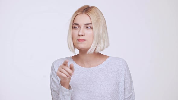 Young Beautiful Blonde Girl Remembering Something Over White Background