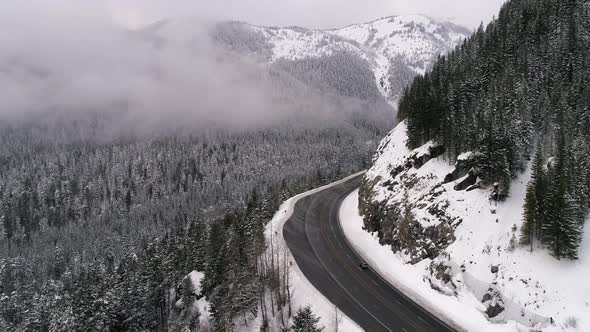 Winter Highway Roadtrip Aerial In Snowy Mountain Forest