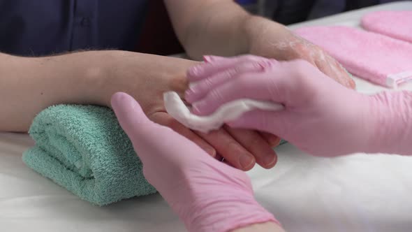 Removing cream from a man's hands