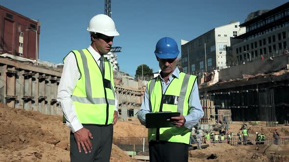 Mature men meeting on construction site