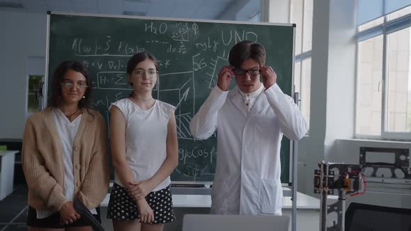 Young Students and Teacher Stand in the Classroom