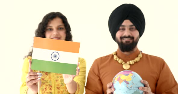 Young Man and Indian Woman Holding Globe and Flag