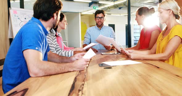 Businesspeople throwing papers