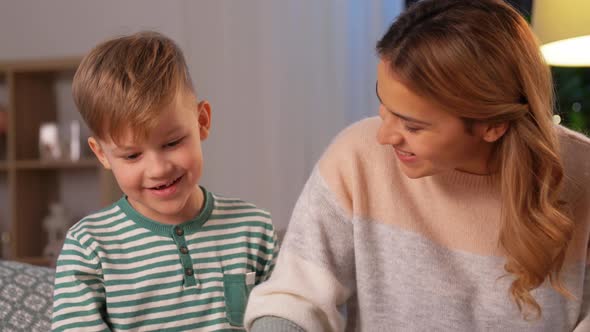 Mother and Son Playing with Toy Cars at Home