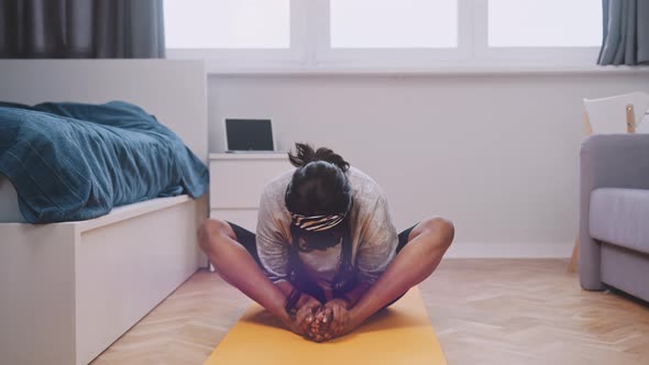 Yoga Teacher Conducting Virtual Class at Home on a Video Conference