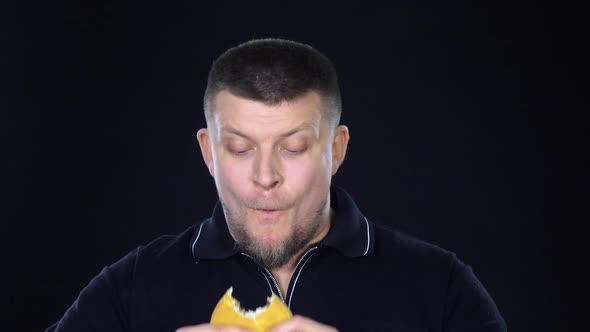 Man Eating a Cheeseburger. Black. Slow Motion