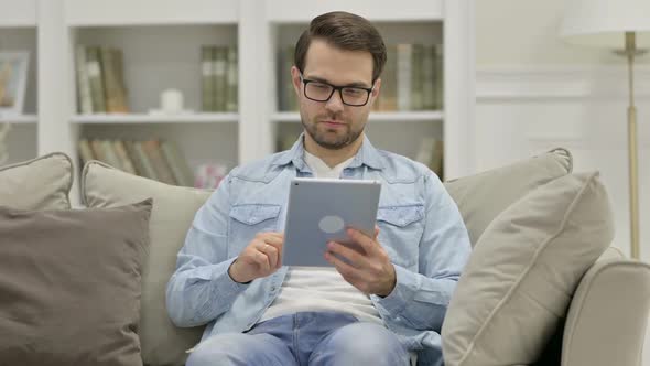 Young Man Using Tablet at Home