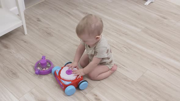 Cute Small Child Playing with Toys 1 Year Old Baby Boy Holding Holding Learning Bot Toy
