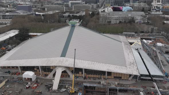 Drone shot pulling away from Climate Pledge Arena to show all of the ongoing construction.