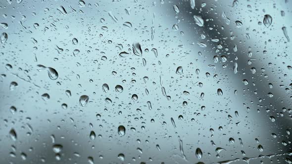 Rain Drops on Side Car Window During Heavy Rain. Slow Motion Shot
