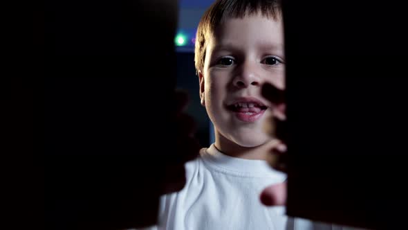 Happy Baby Opens Looks Inside a Cardboard Box and Shows Positive Emotions on His Face, Shot From