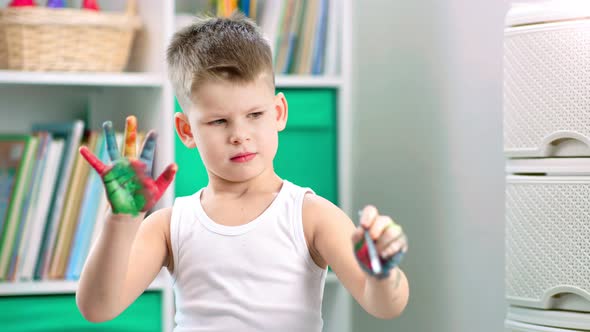 A Creative Child Boy is Sketching Something Using His Hands