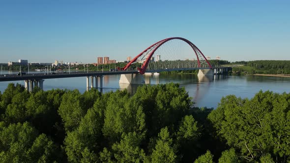 Green Forest Against the Backdrop of a Road Bridge Blue Sky and River