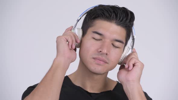 Face of Young Handsome Multi-ethnic Man Listening To Music