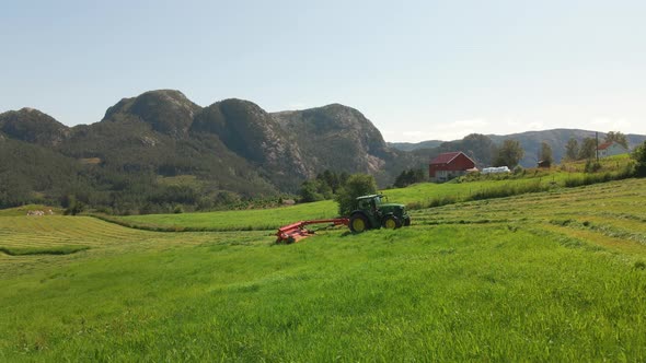 Silage Production - Tractor With Pull-Type Forage Harvester Cutting Green Crops On Uphill Land In Hj