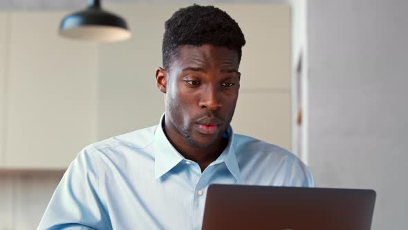 Young man communicating via video call using computer