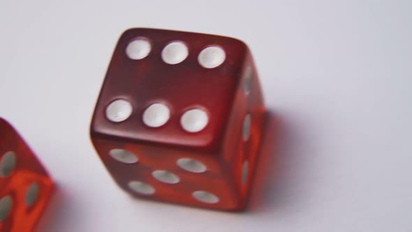 Motion Past Red Plastic Dices with Spots on White Surface