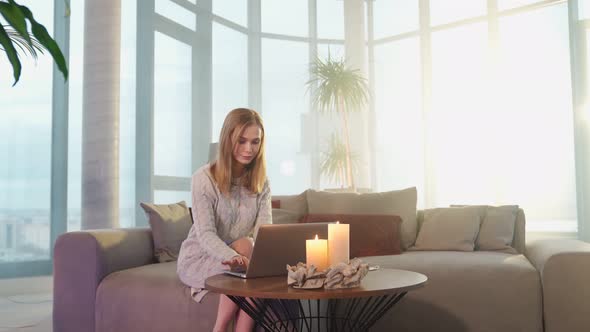 Attractive Woman Using Laptop During Evening Time at Home