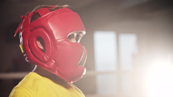 Little Boy Boxer Takes a Punch in His Face in Glove