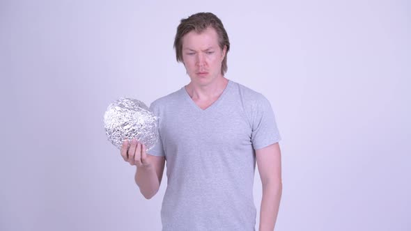 Young Man Wearing Tin Foil Hat As Conspiracy Theory Concept