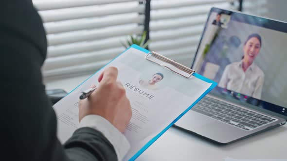 Close up of Asian woman video call with hr manager for job interview.