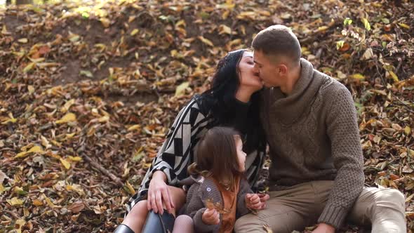 Happy young family resting in the forest