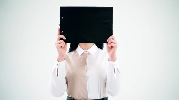 Black folder hides woman face