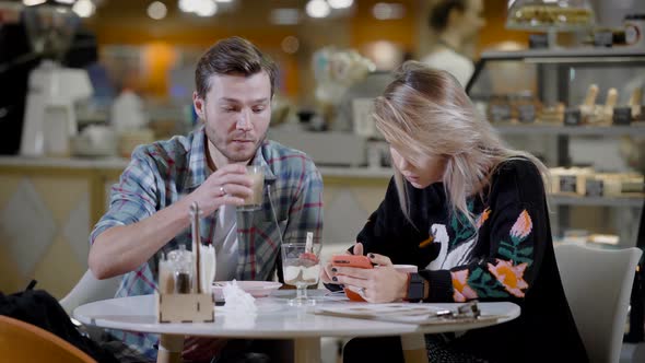 Portrait of a Lovely Couple in Cafe, Boyfriend and Girlfriend on a Date in Cozy Cafe Eating Desserts