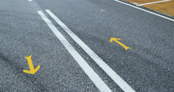 Macro Of Yellow Arrow Road Markings At The Cemented Highway. aerial