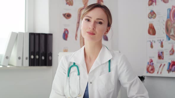 Handheld video shows of female doctor sitting in her office. Shot with RED helium camera in 8K
