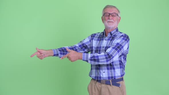 Happy Senior Bearded Hipster Man Pointing Finger and Giving Thumbs Up