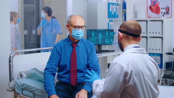 Senior Patient Wearing Mask at Doctor Appointment